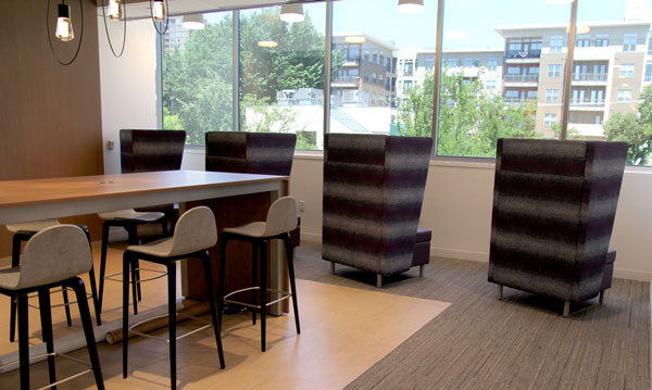 Waiting area - Cafe seating with outlets built into the table and private high back chairs all bathed in natural light.