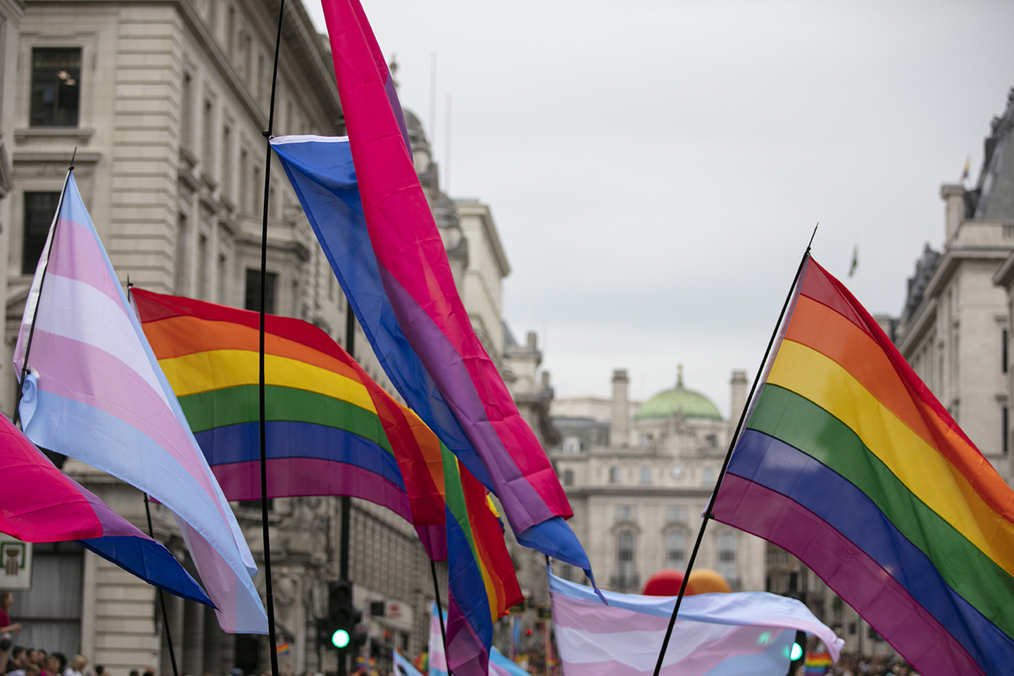 People wave LGBTQ gay pride rainbow flags at a pride event