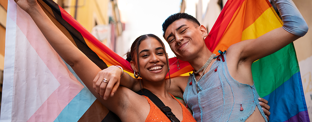 Two Latinx Friends holding a Pride Flag